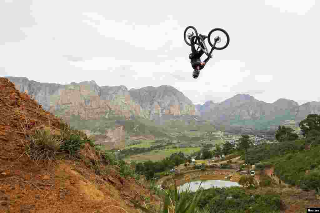 Rider Szymon Godziek from Poland jumps during the Darkfest extreme freeride mountain biking event in Stellenbosch, South Africa.