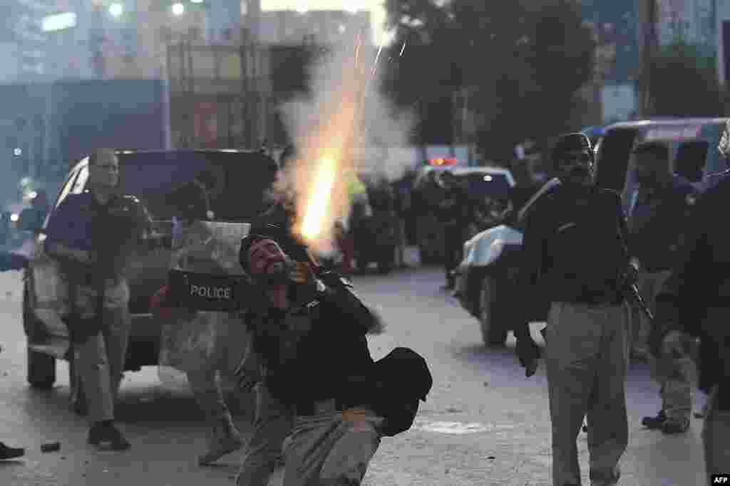Police fire tear gas shells toward Pakistan Tehreek-e-Insaf party activists and supporters of former Pakistan's Prime Minister Imran during a protest in Karachi of the arrest of their leader. Khan was arrested in connection with a graft case.