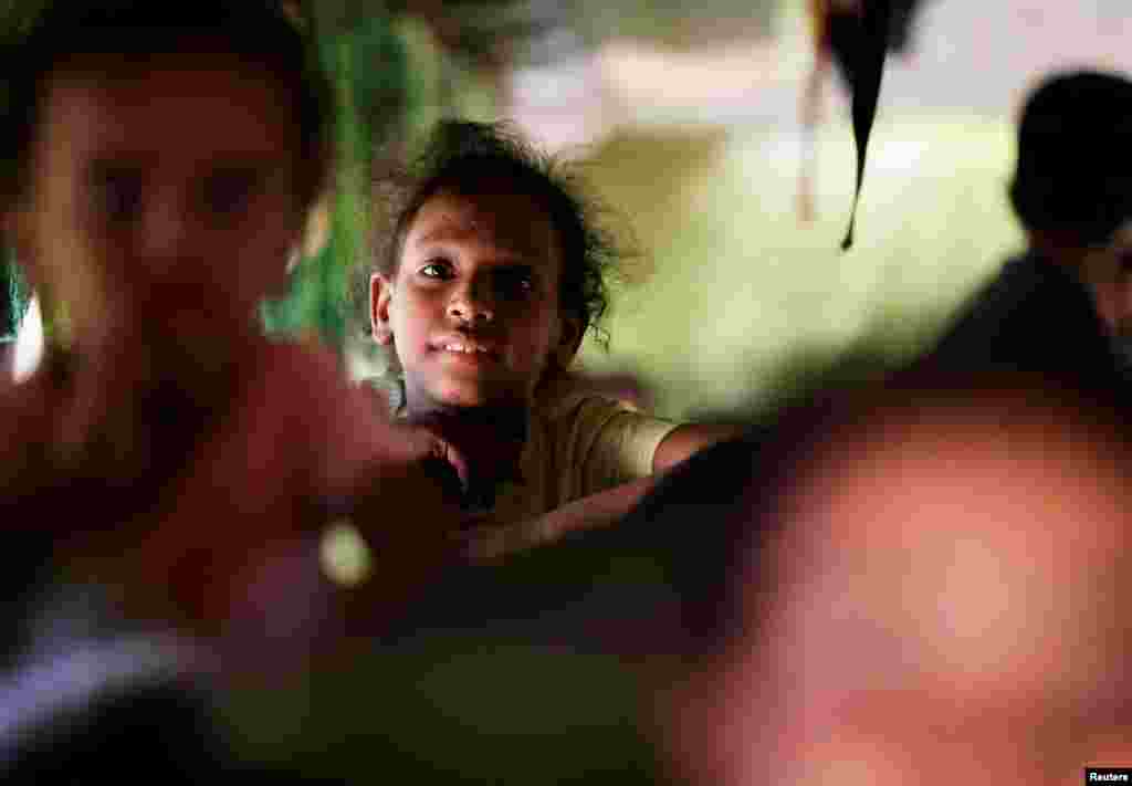 A girl sits in a bus as passengers fleeing Sudan arrive at the Argeen land port, after being evacuated from Khartoum to Abu Simbel city, at the upper reaches of the Nile in Aswan, Egypt.