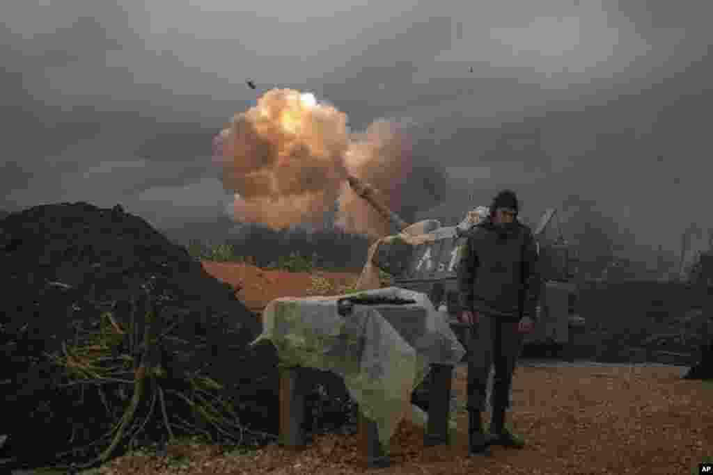 An Israeli mobile artillery unit fires a shell from northern Israel towards Lebanon.