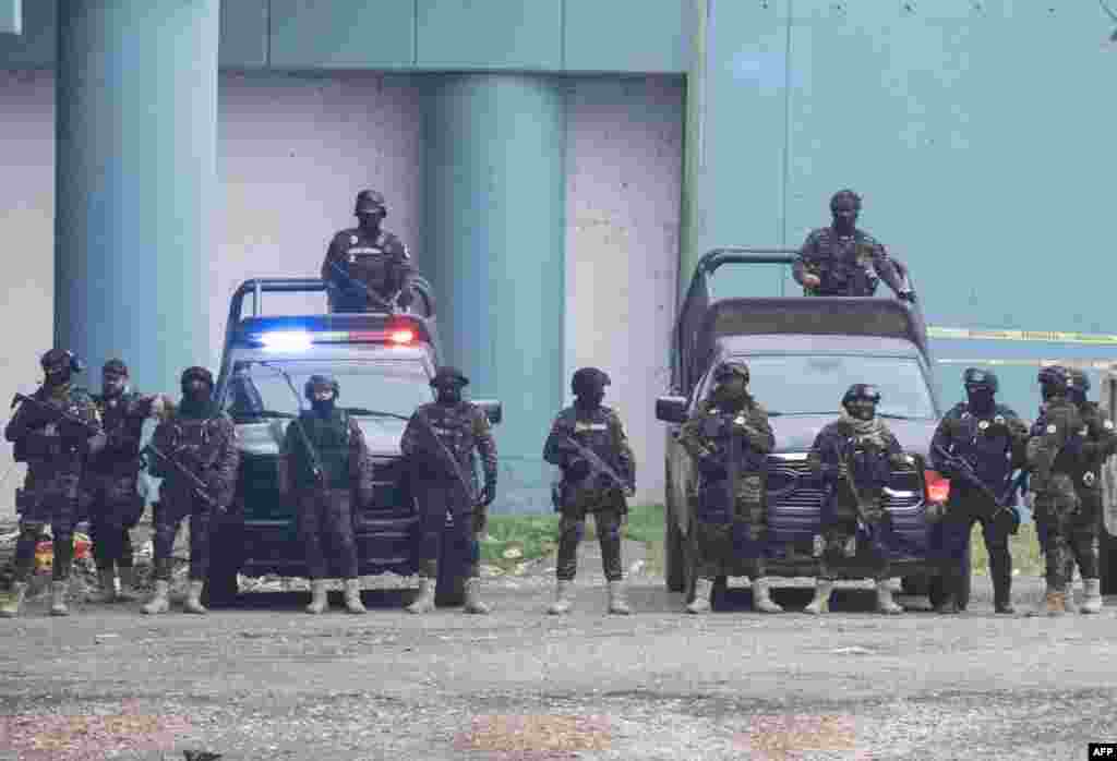 Members of the Mexican police take up positions in a show of force under a bridge that connects the U.S. and Mexico, as seen from Eagle Pass, Texas. The U.S. will officially end on May 11 its 40-month COVID-19 emergency, and the Title 42 law, a tool that has been used to prevent millions of migrants from entering the country.