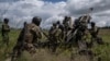 FILE - Ukrainian servicemen prepare to fire at Russian positions from a U.S.-supplied M777 howitzer in Kharkiv, Ukraine, on July 14, 2022. VOA has learned the U.S. will provide up to $150 million in additional military aid for Ukraine as soon as Oct. 25, 2023.