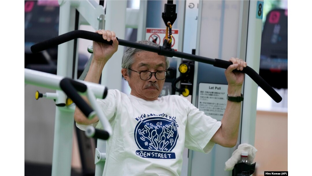 FILE - For resistance training, Toshiyuki Honma, 70, uses a pulldown weight machine as he works out at the Fukagawa Sports Center in Tokyo, June 12, 2024. (AP Photo/Hiro Komae)