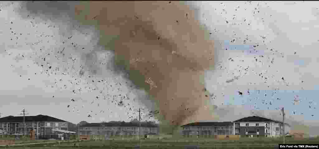 Debris is lifted into the air by a possible tornado during severe weather near Greenwood, Indiana, June 25, 2023 in this screen grab obtained from a social media video.