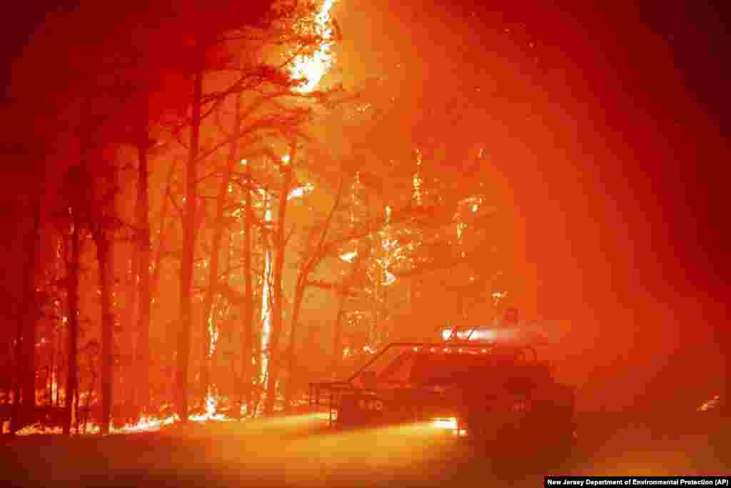 A massive wildfire tears through 3,800 acres in the state's pine barrens in Ocean County, New Jersey, as firefighters battle the blaze with 200-foot high flames. No one was injured and property was intact, officials.