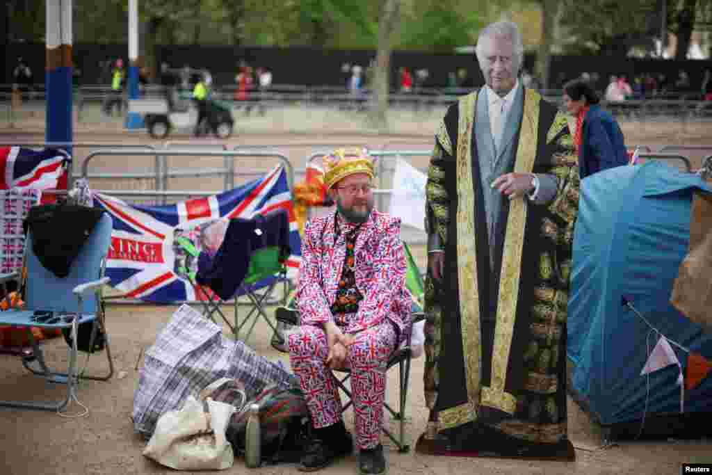 Royal fans wait at the Mall, ahead of the Coronation of Britain's King Charles and Camilla, Queen Consort, in London.