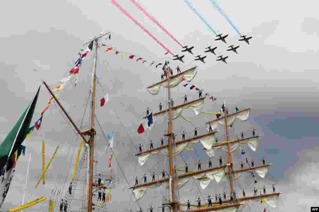 French aircraft patrol "Patrouille de France" planes fly over the Cuauhtemoc ship during the Grand Parade during the Armada of old vessels and tall ships in Rouen, June 18, 2023.