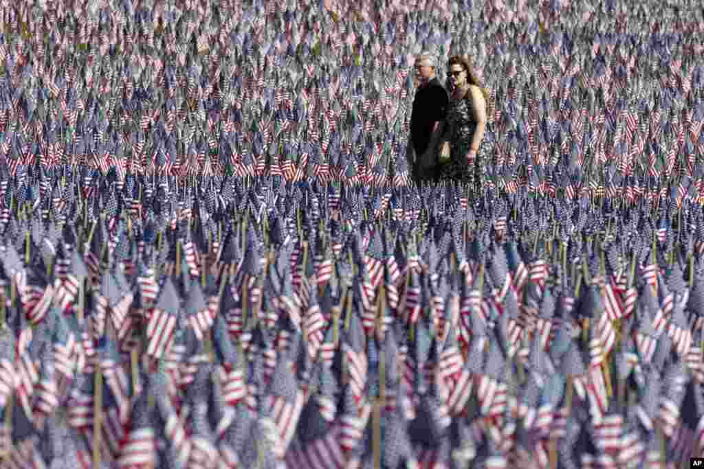 A couple walks through the Memorial Day Flag Garden on Boston Common, May 27, 2023, in Boston, Massachusetts. 