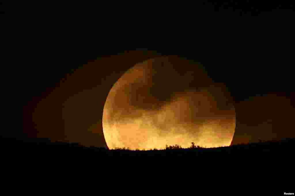 A full moon known as a ''Worm Moon'' rises over Dajti Mountain in Tirana, Albania, March 25, 2024. 