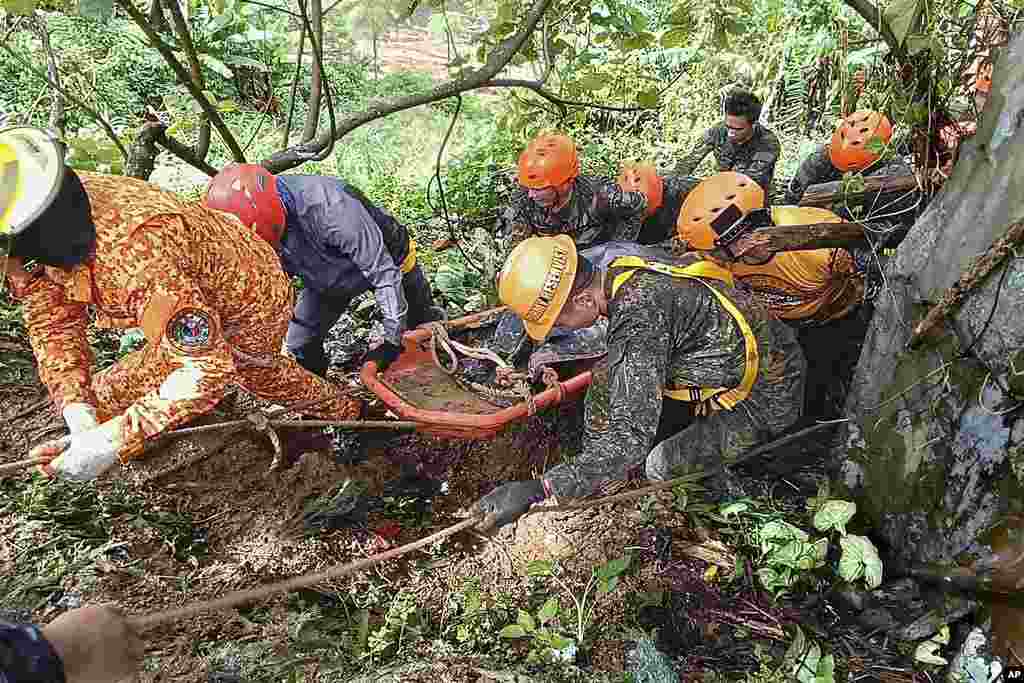 Rescuers retrieve a body of one of the victims after a landslide due to heavy rains at Monkayo town in Davao de Oro province, southern Philippines, in this handout photo provided by the Municipality of Monkayo.