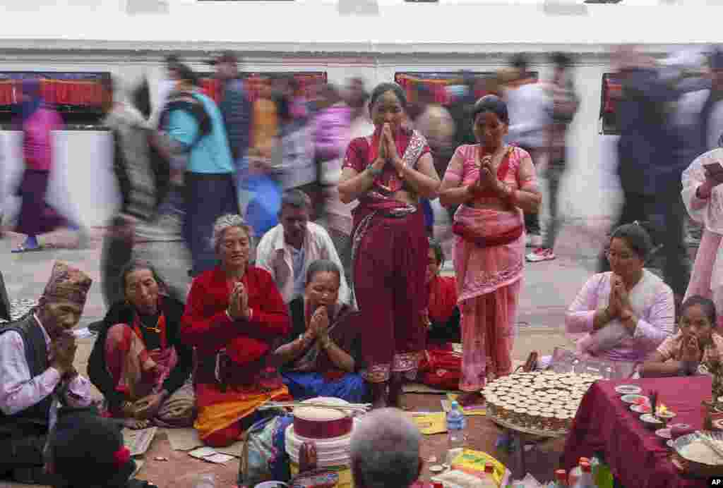 Tamang community people perform rituals during the Temal festival at Boudhanath Stupa in Kathmandu, Nepal. During this festival, people from the Tamang community gather in nearby monasteries to pay homage to their loved ones who have passed away. 