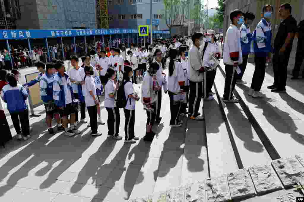 Students line up to enter a school on the first day of China's national college entrance examination, known as the gaokao, in Beijing.