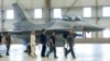 FILE - Ukrainian President Volodymyr Zelenskiy and Dutch Prime Minister Mark Rutte walk past an F-16 fighter jet in Eindhoven, Netherlands, Aug. 20, 2023.