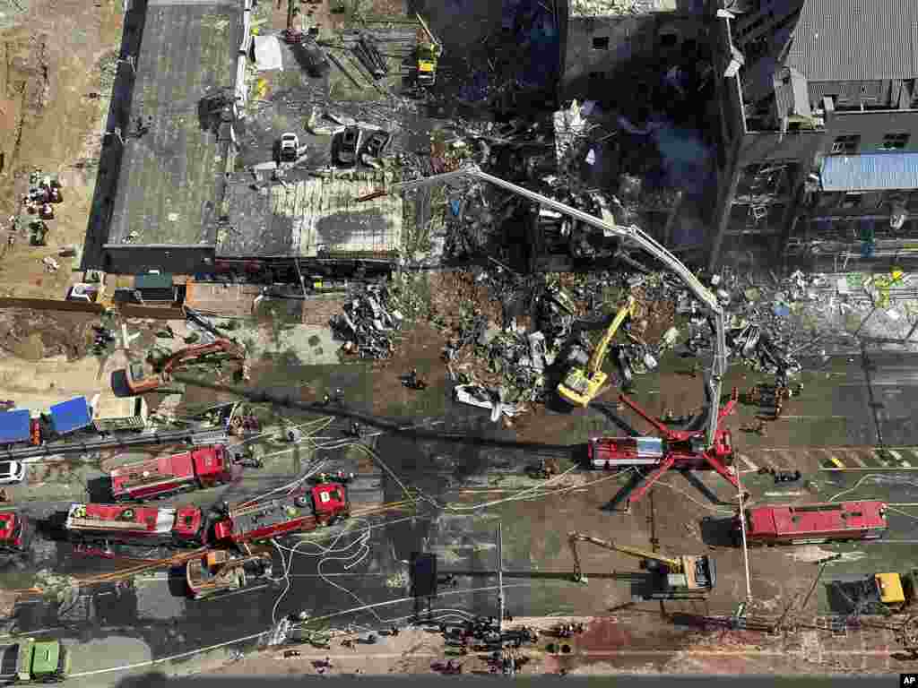 Firefighters work the scene of an explosion in Sanhe city in northern China’s Hebei province. An explosion caused by a suspected gas leak has ripped through a building, killing at least two people and injuring 26 others.