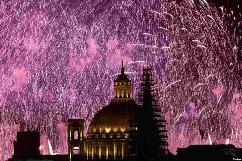 Fireworks explode behind the steeple of St. Paul's Anglican Pro-Cathedral and the dome of the Basilica of Our Lady of Mount Carmel during the Malta International Fireworks Festival in Valletta, Malta, April 30, 2023.