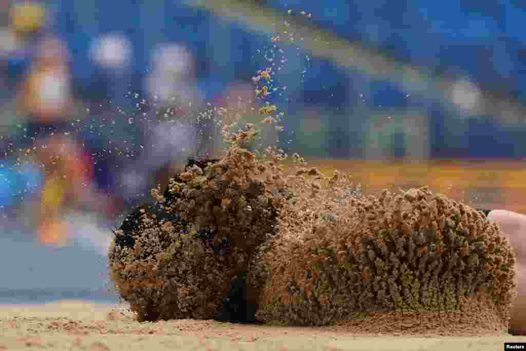 Turkey's Ecem Calagan lands in the sand after sustaining an injury during the Women's Long Jump during the European Games Athletics Championships at the Silesian Stadium in Chorzow, Poland.