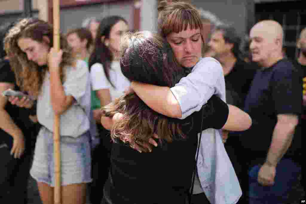 Telam workers hug outside the state-run Telam news agency in Buenos Aires, Argentina. Télam's employees were laid off and unable to enter the facility after President Javier Milei announced its closure on March 1.