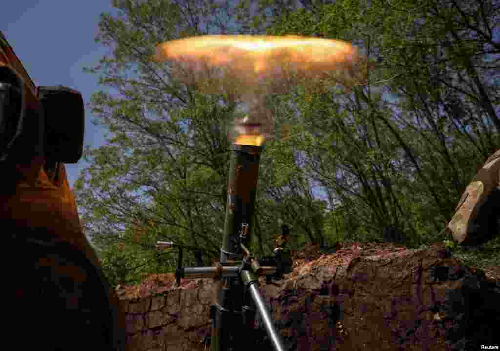 Ukrainian service members fire a mortar at a front line near the city of Bakhmut in Donetsk region.