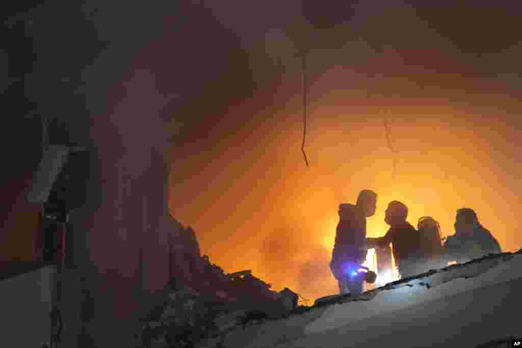 Firefighters extinguish the fire inside an apartment following a massive explosion in the southern suburb of Beirut, Lebanon. The TV station of Lebanon's Hezbollah group said top Hamas official Saleh Arouri was killed in the explosion. 