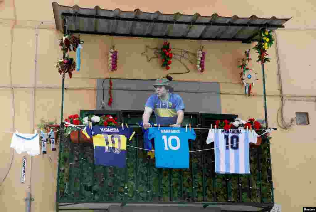 A cardboard cutout of Diego Maradona and football jerseys are pictured on a balcony ahead of Napoli potentially winning Serie A, in Naples, Italy.