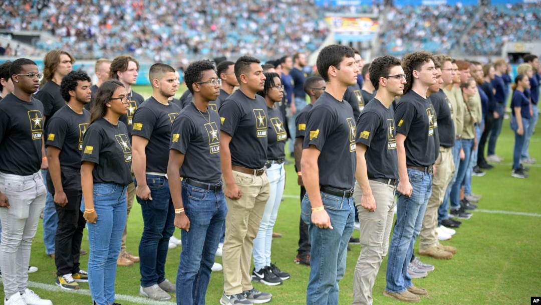 In this file photo, military recruits are sworn in during an NFL football game between the Jacksonville Jaguars and the Las Vegas Raiders, Nov. 6, 2022, in Jacksonville, Fla. (AP Photo/Phelan M. Ebenhack, File)