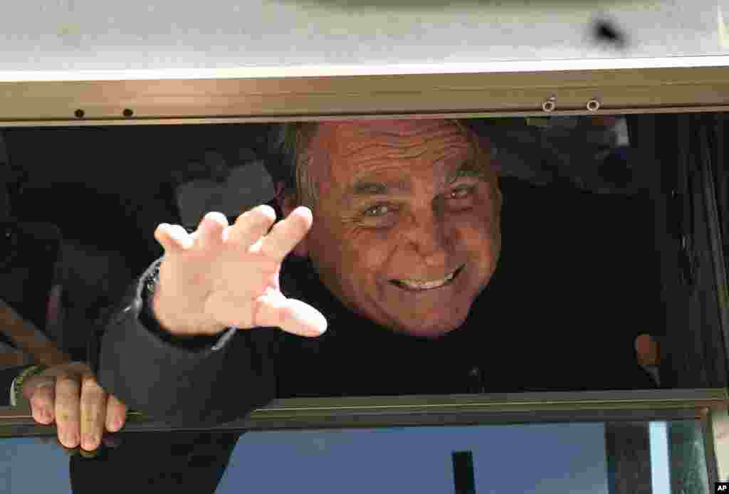 Brazil's former President Jair Bolsonaro waves to supporters at the Liberal Party's headquarters in Brasilia, Brazil. Bolsonaro arrived back in Brazil on Thursday after a three-month stay in Florida, seeking a new role on the political scene.