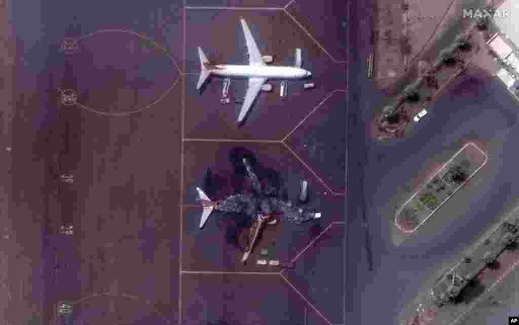 This satellite image provided by Maxar Technologies shows a destroyed Ukrainian airplane in Khartoum International Airport, Sudan, April 17, 2023. The Sudanese military and a powerful paramilitary group are battling for control of the chaos-stricken nation for a third day.
