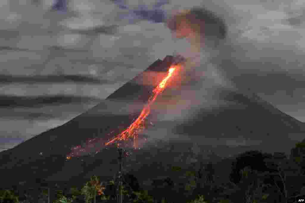 Lava flows during an eruption of Mount Merapi, Indonesia's most active volcano, as seen from Tunggularum village in Sleman.