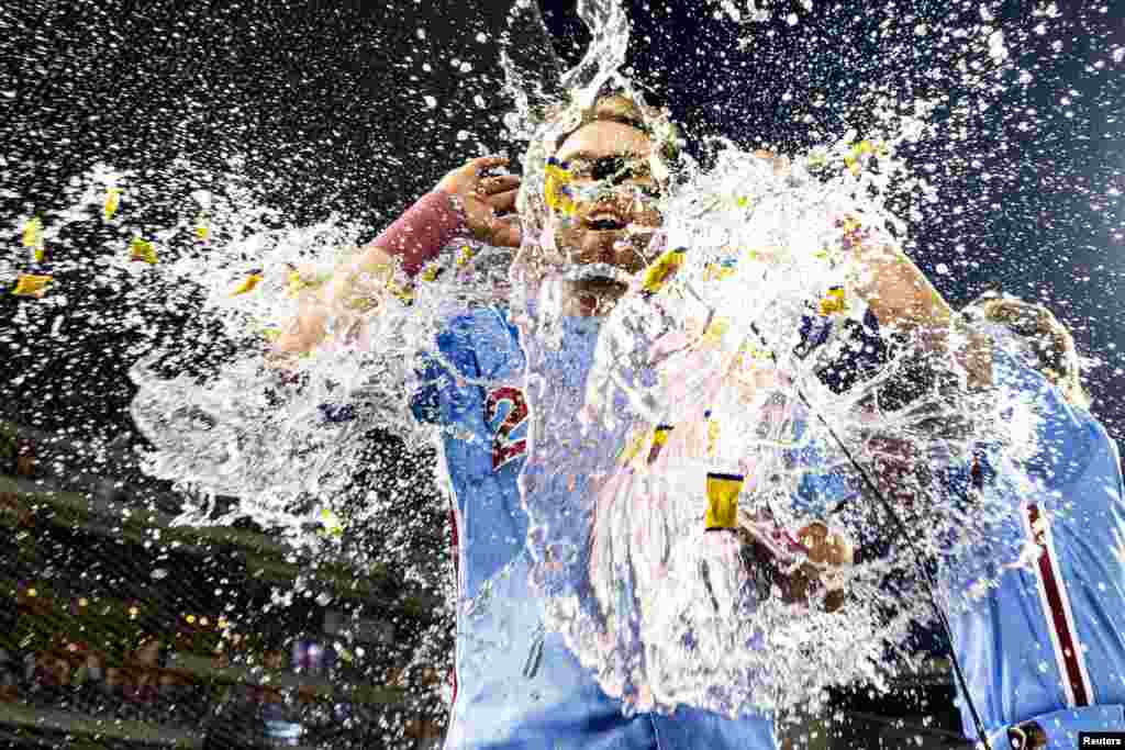 Philadelphia Phillies first baseman Kody Clemens (23) is doused by water after hitting a walk off game-winning RBI single during the ninth inning against the Detroit Tigers in Philadelphia, June 8, 2023. (Bill Streicher/USA Today Sports/via Reuters)