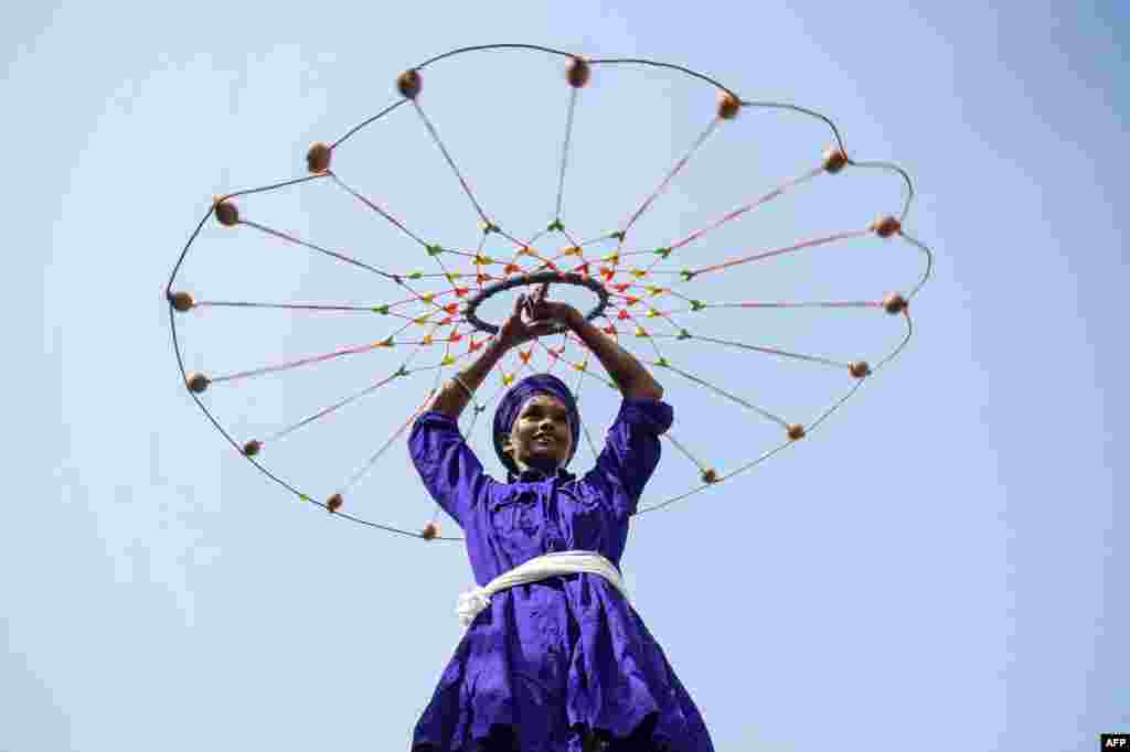 A young man performs 'Gatka', an ancient form of the Sikh martial art, during a Sikh religious procession to mark the birth anniversary of Shaheed Baba Jiwan Singh in Amritsar, India.
