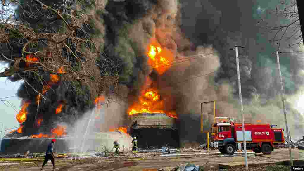 Firemen work to extinguish fire after a blast at an oil terminal in Conakry, Guinea. The death toll from the blast has risen to 13, a senior police source said.