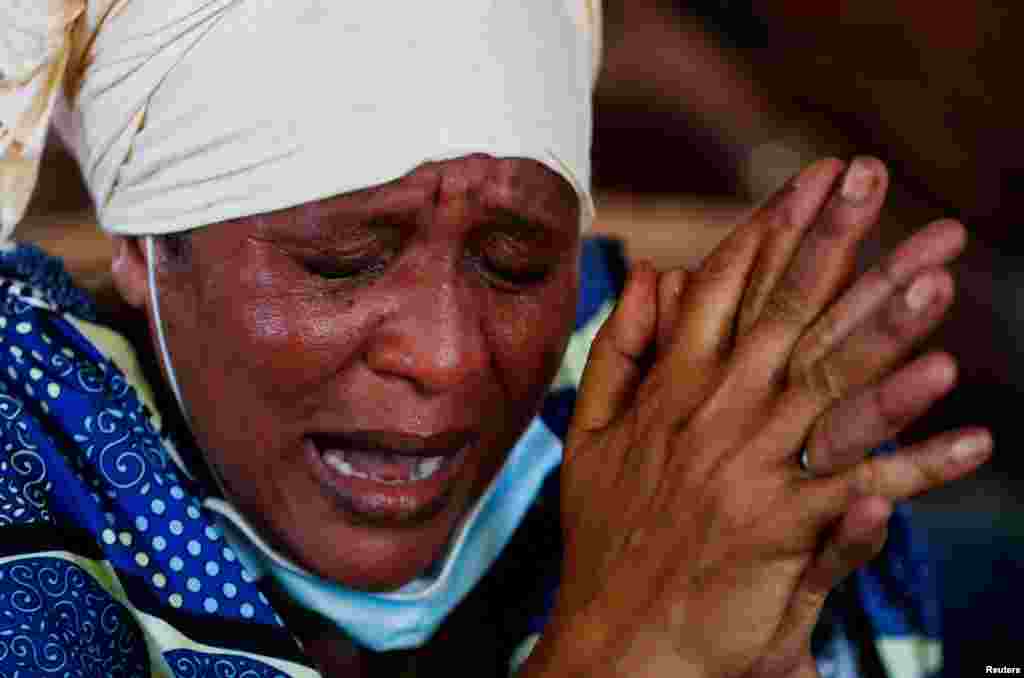 Pers Jacob, a relative reacts after viewing the exhumed remains of Esther Biriya Masha who was a follower of the Christian cult named Good News International Church, who believed they would go to heaven if they starved themselves to death in Shakahola, as the authorities begin to hand over bodies to family members at the Malindi sub-district hospital mortuary, Kenya.
