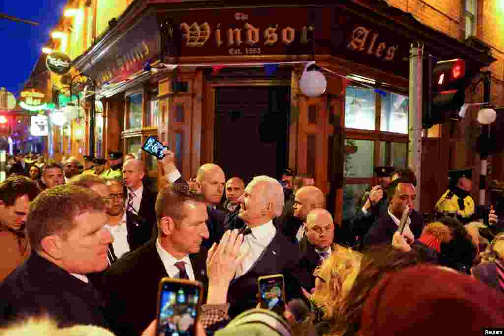 U.S. President Joe Biden takes a selfie outside a pub during his visit to Dundalk, Ireland.