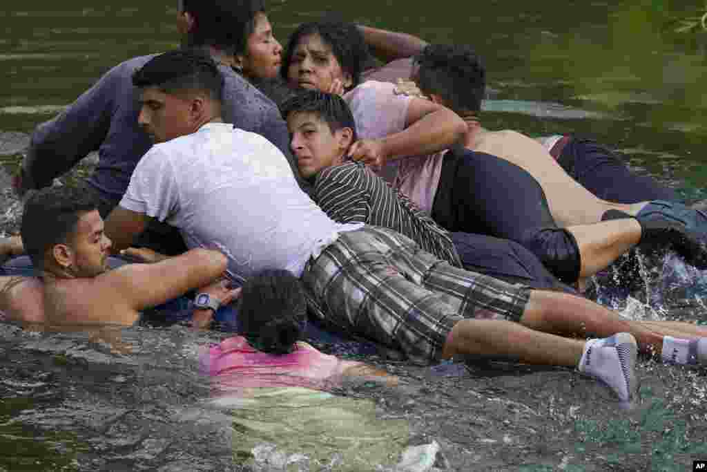 Migrants cross the Rio Bravo on an inflatable mattress into the United States from Matamoros, Mexico, May 9, 2023.