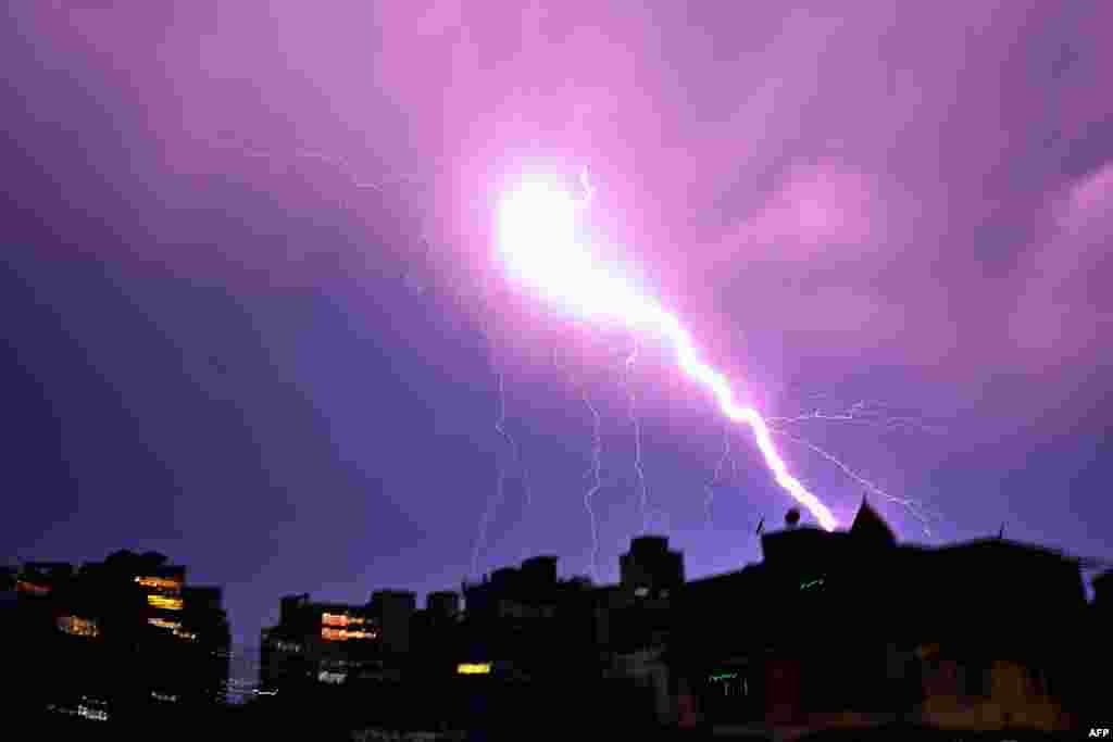 Lightning illuminates the night sky during a storm in Guwahati, India.