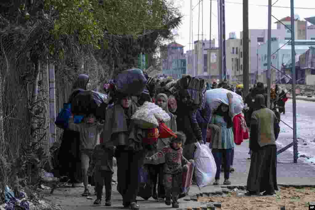 Palestinians arrive in the southern Gaza town of Rafah after fleeing an Israeli ground and air offensive in the nearby city of Khan Younis. Israel has expanded its offensive in Khan Younis, saying the city is a stronghold of the Hamas militant group.
