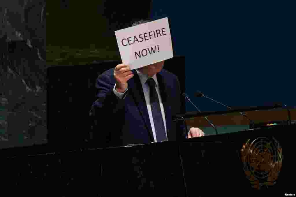 Palestinian U.N. envoy Riyad H. Mansour holds up a sign during a plenary meeting on the 'Use of the veto - Item 63: Special report of the Security Council', in the General Assembly Hall at U.N. headquarters in New York City.
