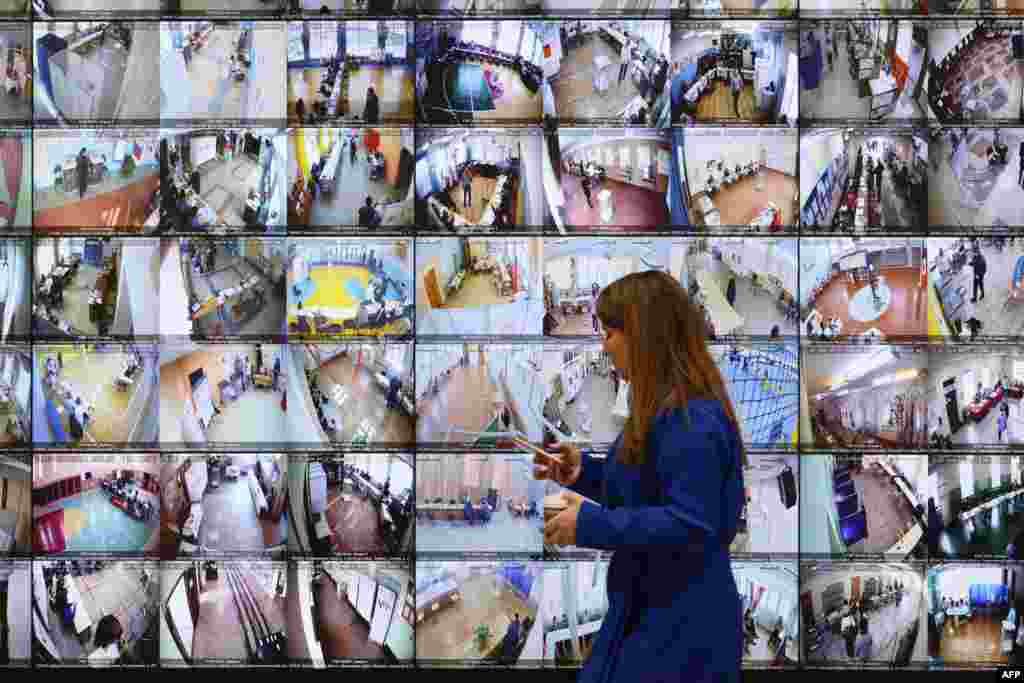 A huge screen broadcasting live feed from polling stations across Russia sits in the country's Central Electoral Commission (CEC) headquarters in Moscow, the first day of voting in the presidential election.