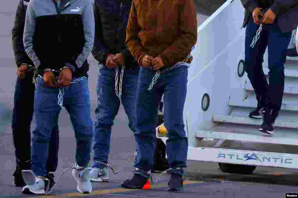 Migrants, transferred from Plattsburgh, New York to El Paso, Texas, disembark from a plane at the airport, in El Paso, Texas, March 21, 2023.
