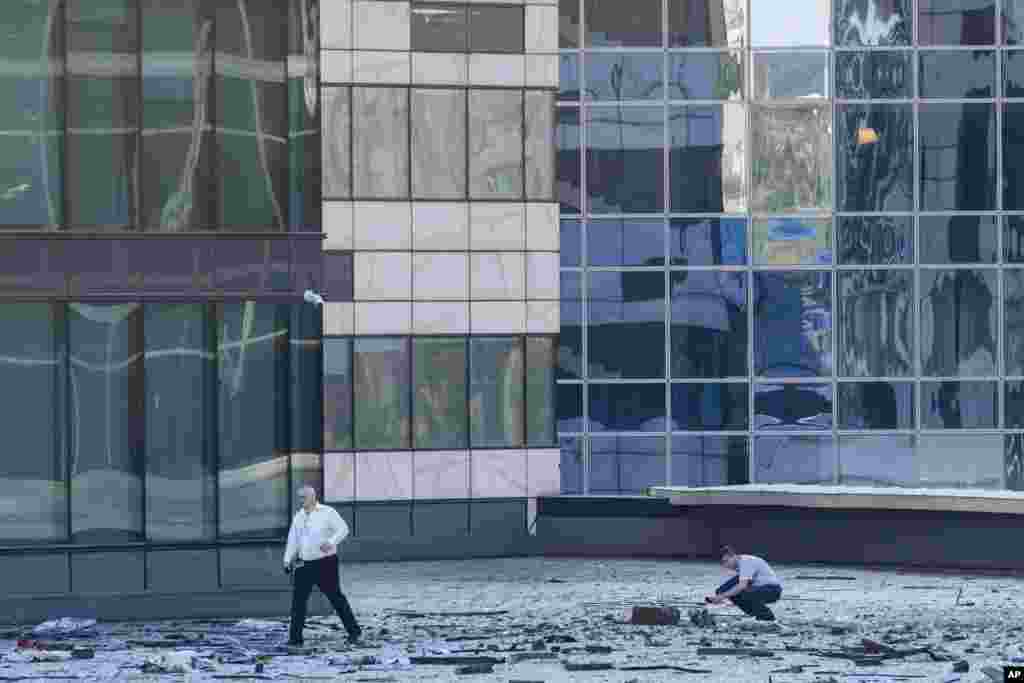 Investigators examine a damaged building in the "Moscow City" business district after a reported drone attack in Moscow, Russia. Ukrainian drones again targeted Moscow and its surroundings, the Russian military reported.