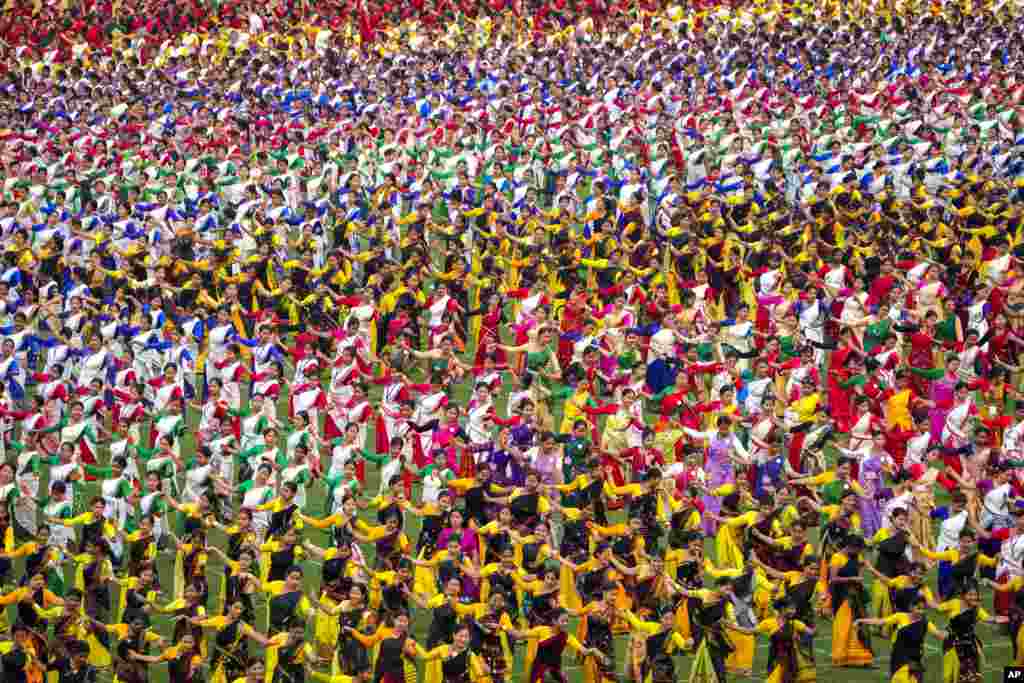 Assamese dancers in traditional attire practice Bihu dance ahead of an event in Guwahati, India. Around 11,000 Bihu dancers and musicians will perform together for Guinness World Record in the largest folk dance performance category on April 14.
