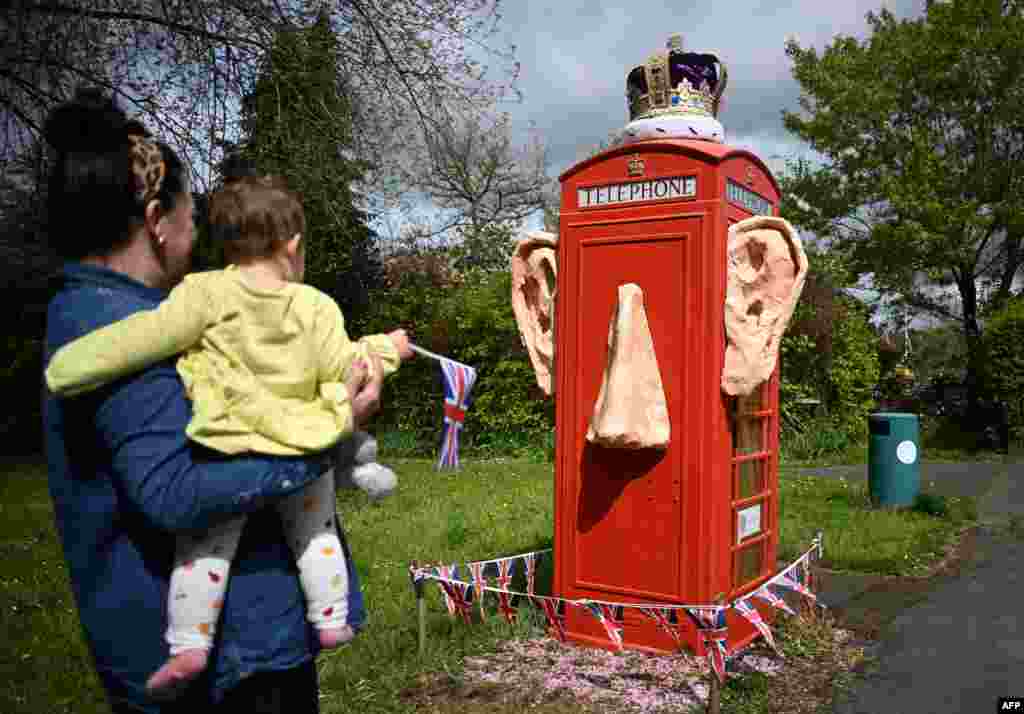 A refurbished telephone call box decorated with the ears and crown of King Charles III, is pictured in the village of Compton, Surrey, west of London, ahead of the coronation weekend.