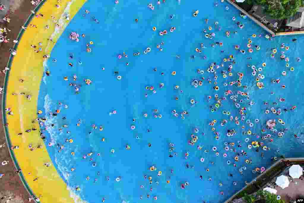 People cool off at a water park in Nanjing, in China's eastern Jiangsu province, Aug. 7, 2027.