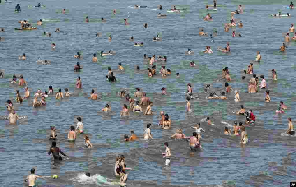 People enjoy the sea in Biarritz, in the southwest of France.
