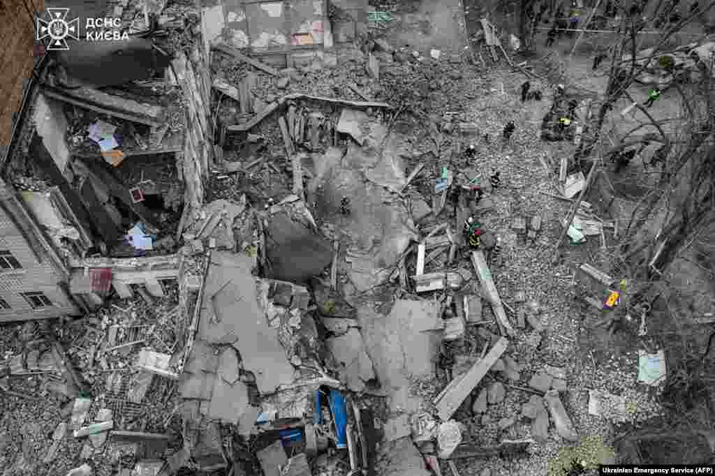 This handout photograph taken and released by Ukrainian Emergency Service shows rescuers working at the site of a missile attack in Kyiv, Ukraine. Five people including a teenage girl were injured during a Russian missile attack on Kyiv. Russia has escalated aerial attacks on Kyiv in recent days, targeting key infrastructure in the wake of fatal Ukrainian bombardments on Russian border regions. 