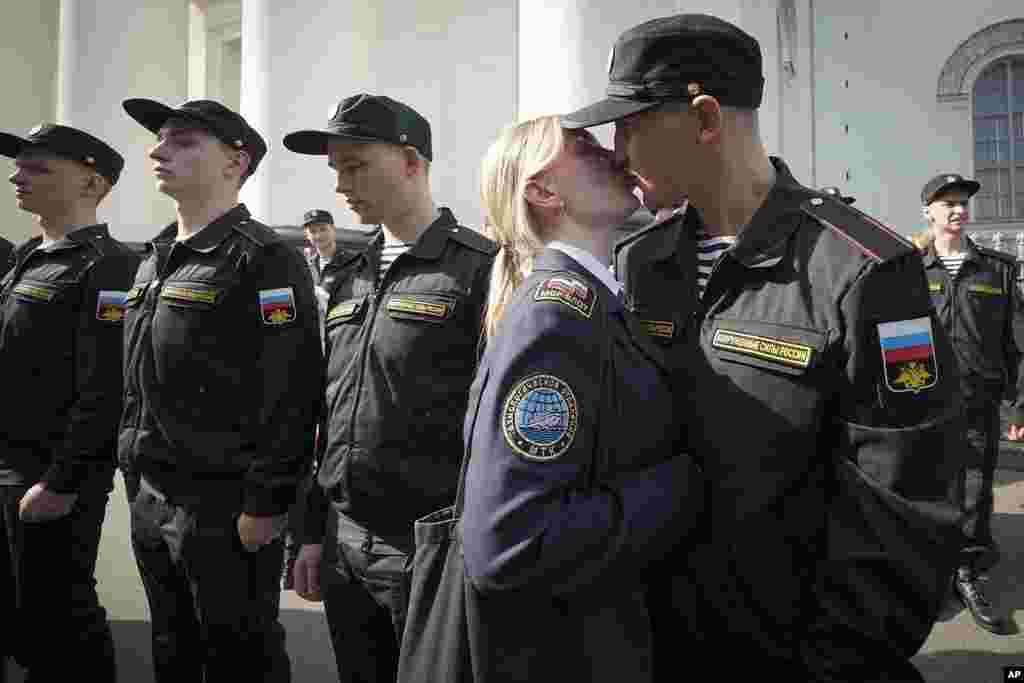 A Russian conscript kisses his partner during a send-off event before they head to assigned military units for mandatory one-year military service, in St. Petersburg, Russia.