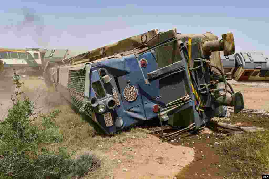 A derailed locomotive is seen at the scene of a train accident near Msaken, about 150 kilometers (95 miles) south of the capital in eastern Tunisia. Two people were killed and 34 injured when an overnight passenger train careered off the tracks and overturned, the state-owned SNCFT rail company said. 