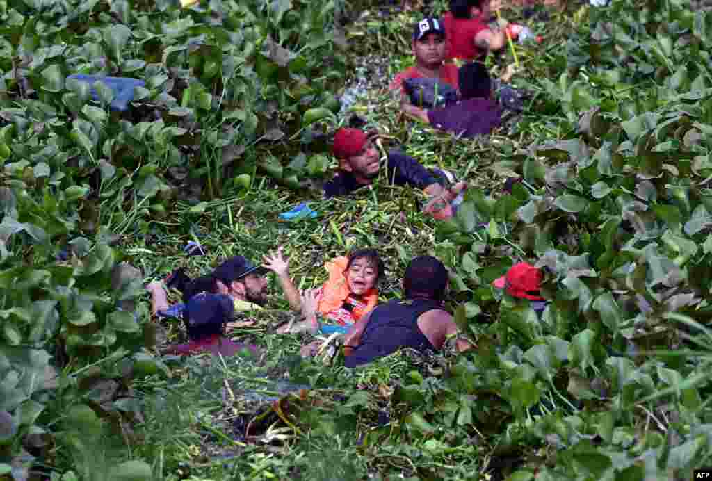 Migrants cross through the banks of the Rio Grande River to the U.S., as seen from Matamoros, state of Tamaulupas, Mexico, May 9, 2023. 