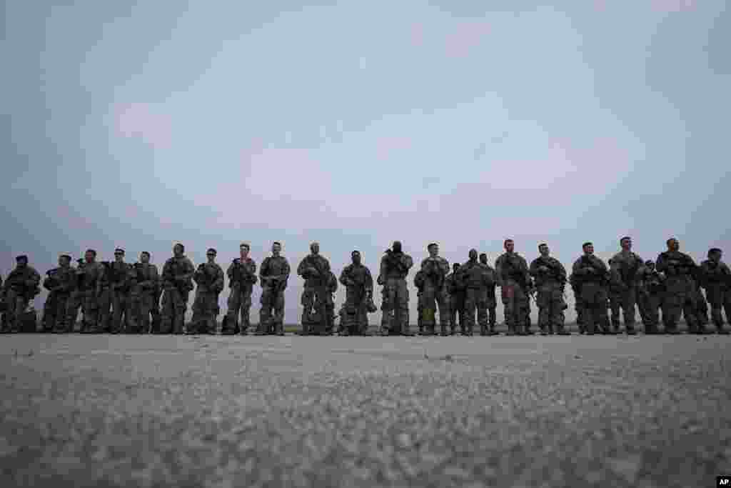 Members of the Texas National Guard prepare to deploy to the Texas-Mexico border in Austin, Texas.