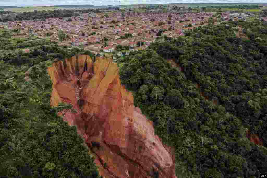 Aerial view of erosions in Buriticupu, Maranhao state, Brazil, taken on April 21, 2023. The city of 70,000 is suffering from the advance of "vocorocas" - "torn earth" in the indigenous Tupi-Guarani language - erosions that begin as small cracks in the ground and grow into large craters that, seen from the air, look like advancing canyons swallowing up chunks of the town. 